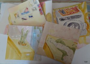 A bunch of paintings that are on the floor