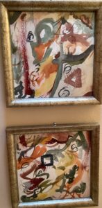 Two framed paintings of abstract shapes and colors.